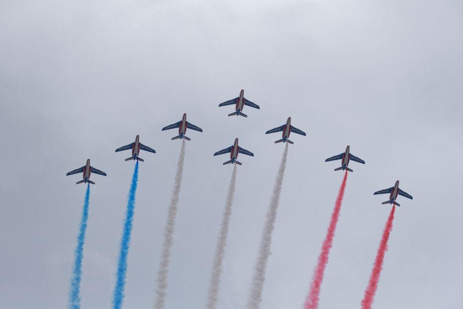 Seven jets of Patrouille de France perform with tricolor smoke at the Paris Air Show.
