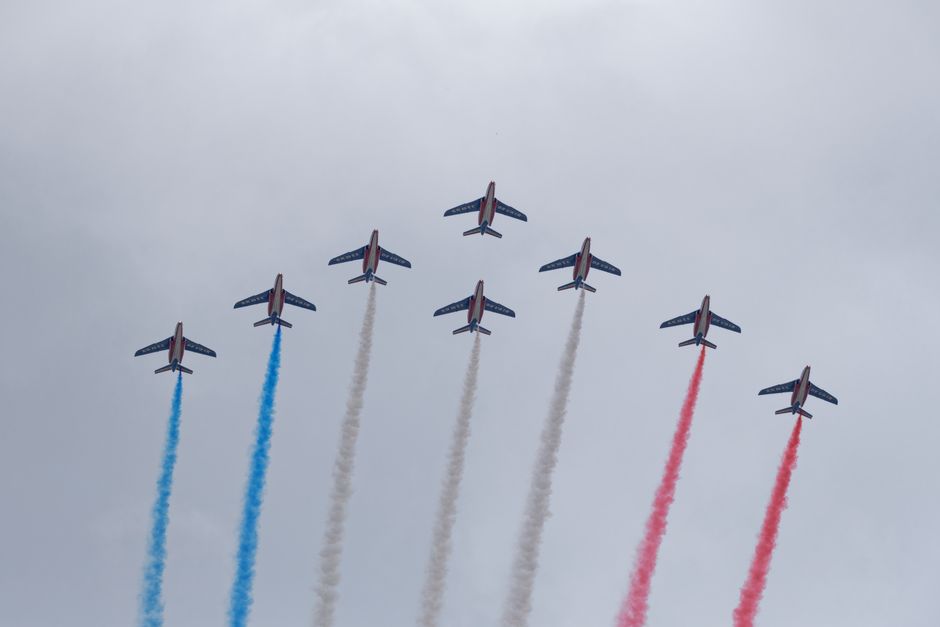 Seven jets of Patrouille de France perform with tricolor smoke at the Paris Air Show.